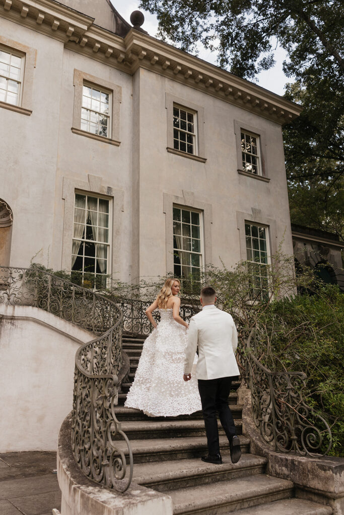 Bride and groom walking up the stairs in a candid portrait