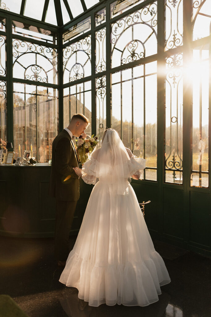candid photo of bride and groom looking at their wedding cake